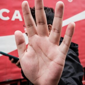 a person with their hand up in front of a coca - cola truck